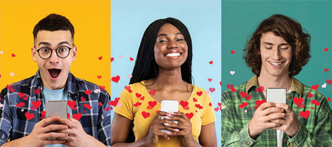 A group of people on their phones smiling with red hearts.