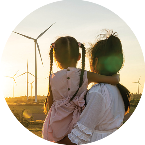 a mother and child watching a wind turbine