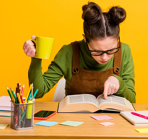 A person looking up terms in a book