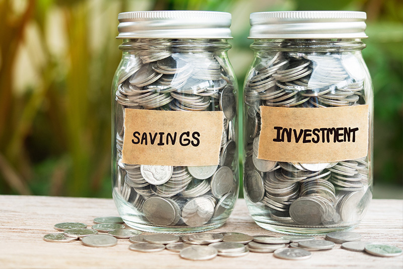 saving and investing jars labelled with money inside of them.
